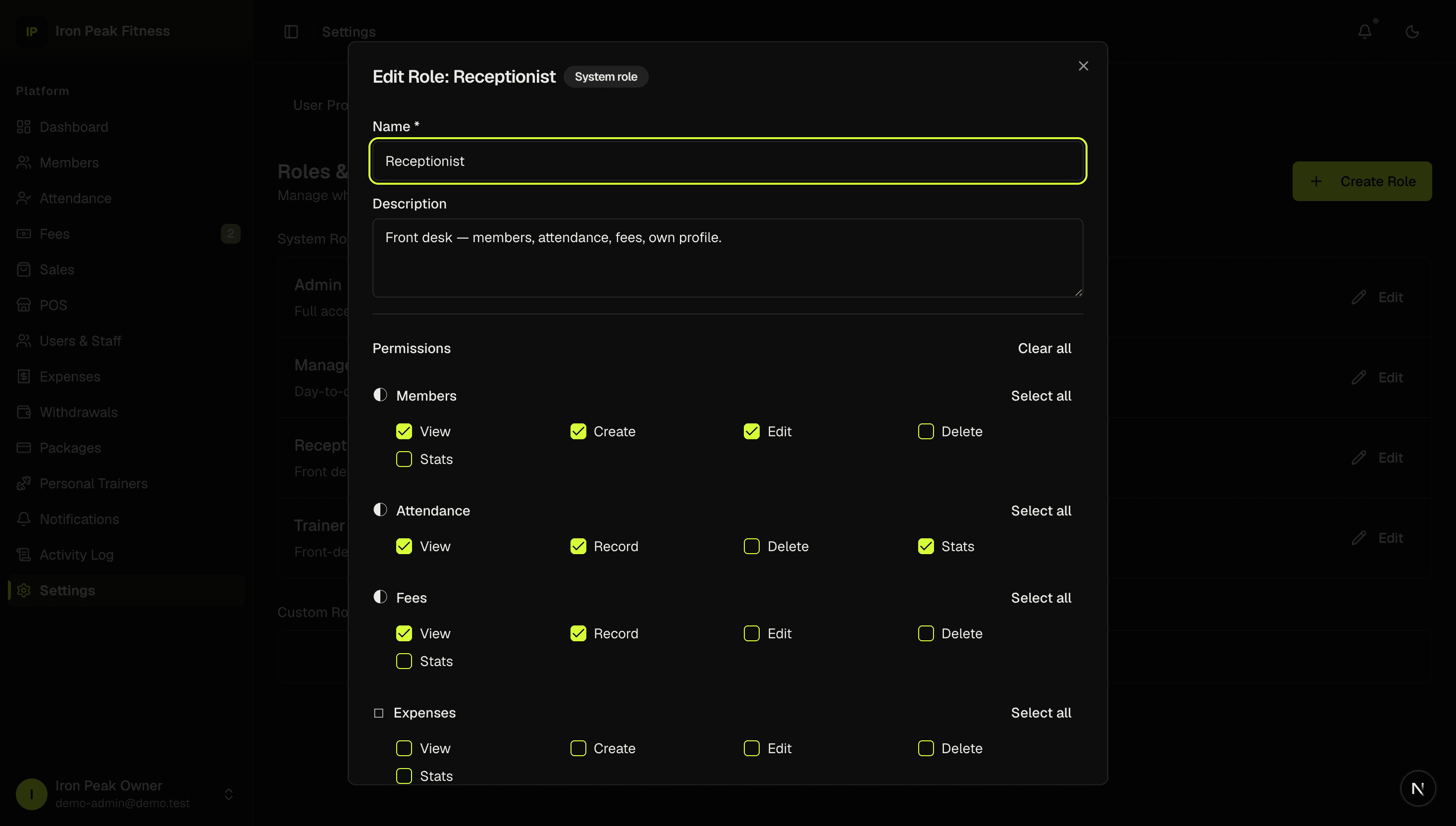GYMORA role editor showing permissions grouped by area — members, attendance, fees, expenses — each with view, create, edit, delete and stats checkboxes